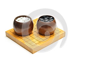 Board Game with black and white stones in bowl called `GO` or weiqi,  igo or Baduk  with copy space