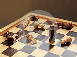 Board game of chess. Wooden chess pieces are lying on a chessboard. Concept logic, strategy, defeat