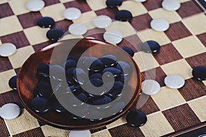 Board game Go and black and white bones. Go or wei-Chi board game