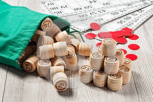 Wooden lotto barrels with bag, game cards and red chops for a ga
