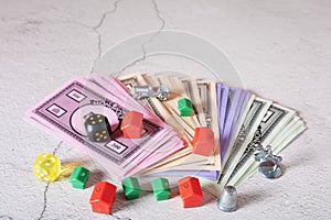 Board game Monopoly, money and figures of houses and hotels