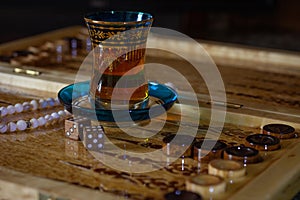 Board games in backgammon, tawla, shesh-besh, kosh. Glass cup for Armudu tea