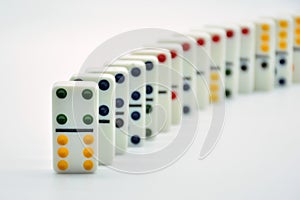 Colored dominoes lined up, domino effect photo