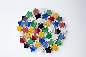 Board games concept. Leader of people nation. Election campaign. White crow. Groups of colorful meeples isolated on gray