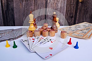Board games on a light background playing cards, bingo, bingo cards, board game chips and chess pieces