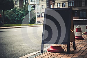 board for inscription on the sidewalk near the coffee shop