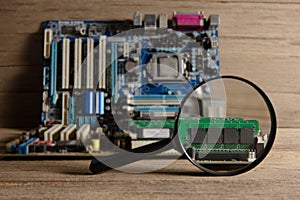 Board with magnifyin on wood background, still life