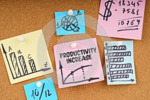 On the board are stickers with graphs and diagrams and the inscription - Productivity Increase