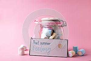 Board with summer theme words, sweet candy marshmallows  in  bank on jar