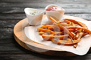 Board with sweet potato fries and sauces