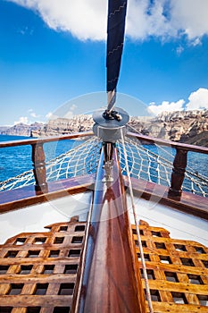 On board view from a traditional ship cruising on Aegean sea next to Santorini island.