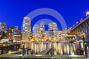 Board walk and marina docking along False Creek at blue hour in Vancouver BC, Canada