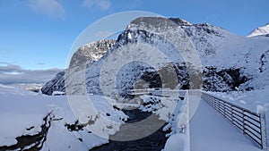 Board walk of Visitor centre on Trollstigen in snow in Norway in autumn