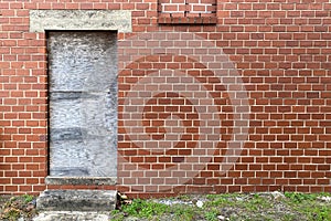 Boarded up door way abandoned red brick back alley warehouse