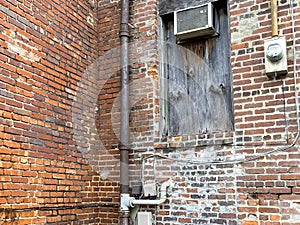 boarded up warehouse alley rusted window brick building