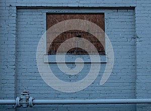 A boarded up window on a condemned building photo