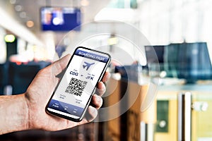 Boarding pass in phone at airport. Electronic flight ticket. Digital mobile app with QR code. Airplane travel with modern airline