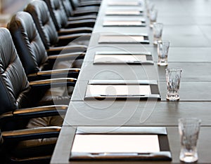 The boardroom table is set for a meeting photo