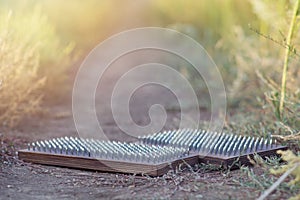 Boards of hobnail for yoga and spiritual practices lie on a country road in the grass in a field. The concept of