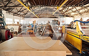 Boards sitting on benches in a woodworking shop photo