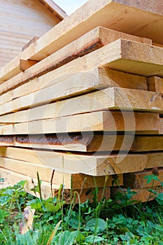 Boards in stack against wooden house