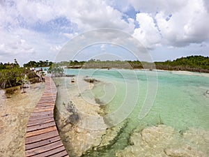 Boardwalk across the clear water and stromatolites in Bacalar