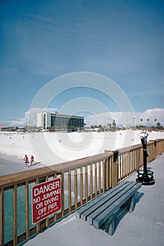 Boardwalk, bench, and sign at the beach