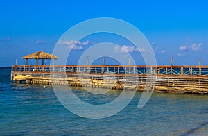 Boardwalk and Cabana Overlooking Caribbean Sea under Blue Sky