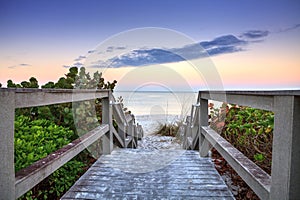 Boardwalk leading down to the white sands along the North Gulf Shore Beach at sunrise photo