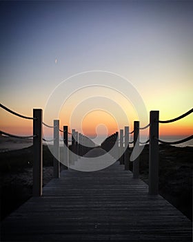 Boardwalk leading to the Atlantic Ocean beach during the sunset, PÃ³voa de Varzim, Portugal, December 2017 photo