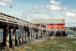 A wood boardwalk out to a marine supply business..