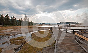 Boardwalk next to Tangled Creek and Black Warrior Springs leading into Hot Lake in Yellowstone National park in Wyoming USA