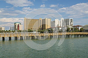 Boardwalk over the lake with brackish water near the buildings in Destin, Florida