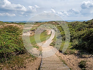 Boardwalk path through sand dunes near Crow Point, North Devon, UK.