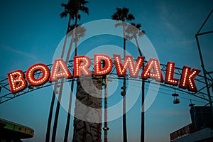 Boardwalk sign with lights and palm trees