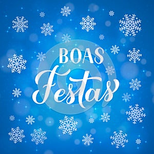 Boas Festas calligraphy isolated on blue background with bokeh and snowflakes. Happy Holidays lettering in Portuguese. Christmas