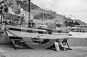 Boat aground with on the background Amalfi and its port, Campania, Italy