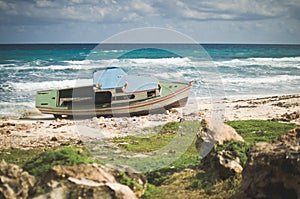 Boat aground on rocky beach, Isla Mujeres, Mexico. photo