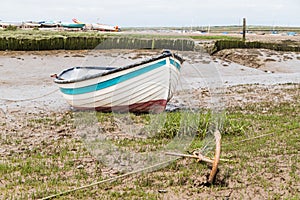 Boat anchored to the shore at Brancaster Staithe