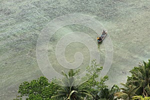 Boat approaching shore in tropical sea destination Pasumpahan island