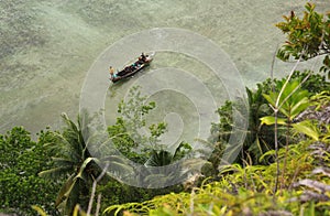 Boat approaching shore in tropical sea destination Pasumpahan island