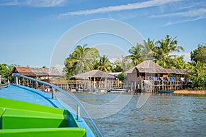 Boat arriving in a traditional indonesian village