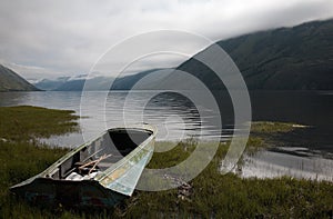 Boat on the bank of mountain lake