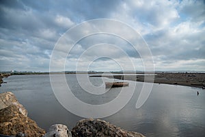 Boat on a beach in Barranquilla on a cloudy day photo