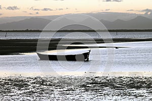 A boat on the beach and montains