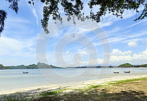 Boat on the beach with sky clouds