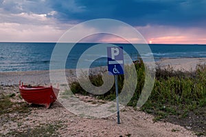 The boat on the beach in stormy weather. It`s raining on the horizon