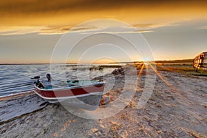 Boat on Beach at Sunrise Over Buffalo Lake, Alberta