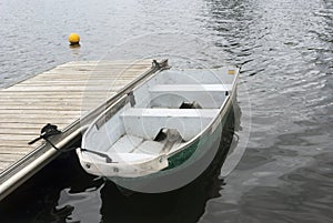 Boat on black lake on cloudy day