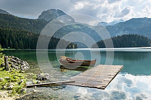 Boat on Black Lake in the national park Durmitor and mountains i